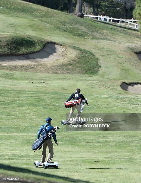 Paul Hodge , president and co-founder of GolfBoard, and former European tour player Chris van der Velde ride GolfBoards up the fairway during a golf...