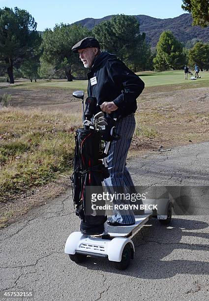 Eighty-year-old Don Wildman rides a GolfBoard during a golf tournament at the Malibu Golf Club in Malibu, California December 9, 2013. The innovative...