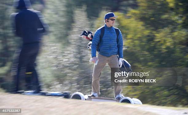 Paul Hodge , president and co-founder of GolfBoard, and former European tour player Chris van der Velde ride GolfBoards up the fairway during a golf...