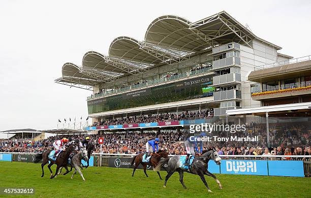 Runners finish the Darley Stakes during The Future Champions Day racing at Newmarket Racecourse on October 17, 2014 in Newmarket, England.