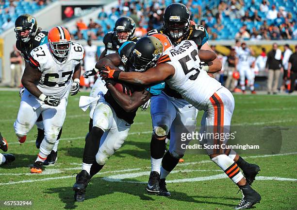 Denard Robinson of the Jacksonville Jaguars carries the ball against Craig Robertson of the Cleveland Browns at EverBank Field on October 19, 2014 in...