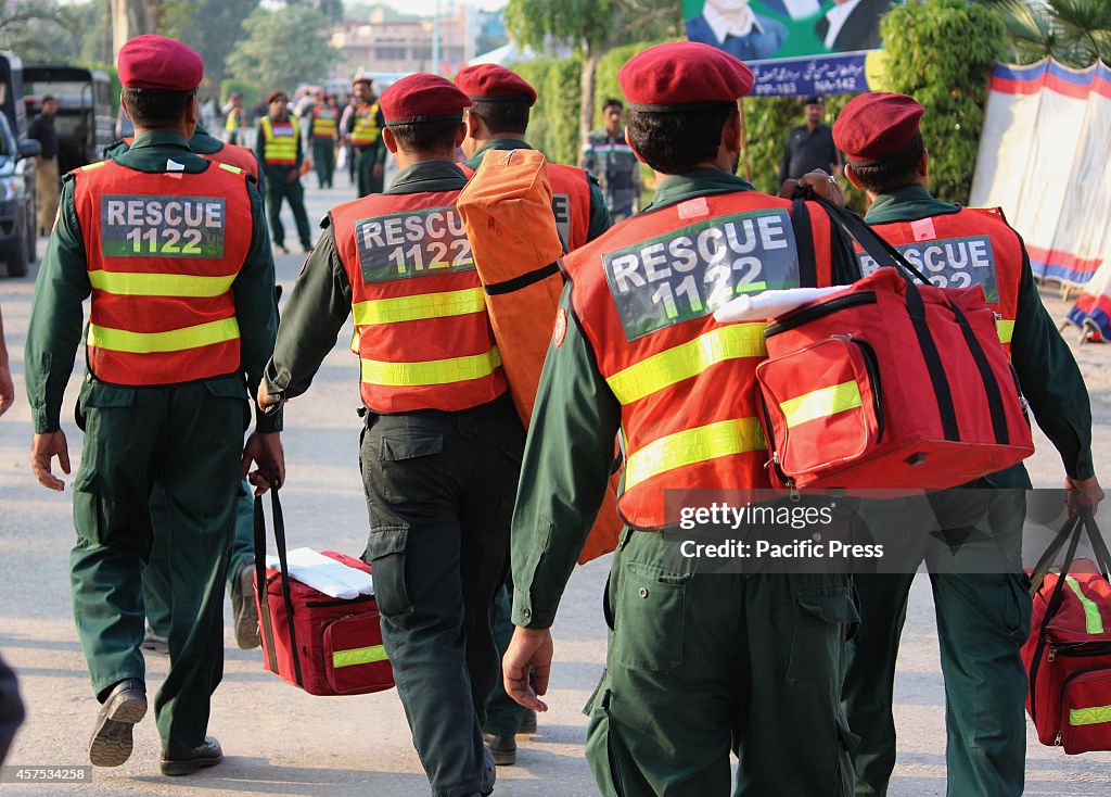 Pakistan's Rescue team carry the first aid items during an...