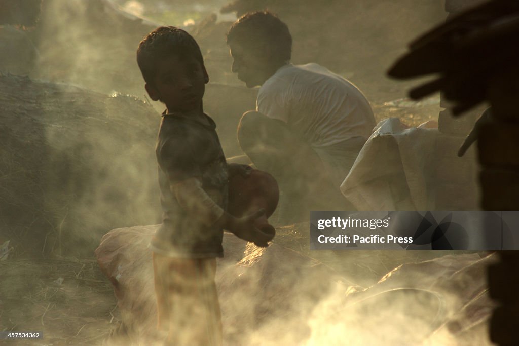 The artisans child standing amidst the smoke. Pottery...