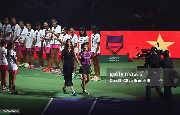 Li Na of China Ambassdor to the WTA Finals walks out on to the court to hit the opening serve at the opening ceremony prior to the start of the...