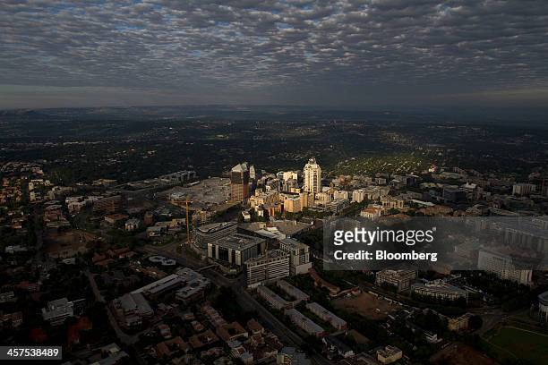 The Michelangelo Hotel, center, stands illuminated by sunlight in the Sandton City central business district in Johannesburg, South Africa, on...