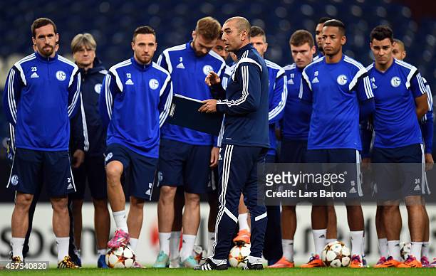 Head coach Roberto di Matteo gives instructions to his players during a FC Schalke 04 training session ahead of their Champions League match against...