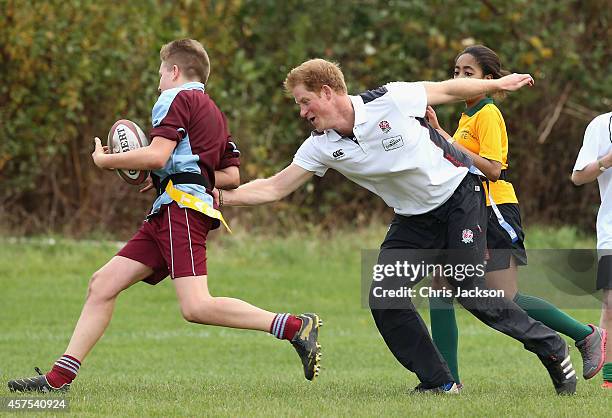 Prince Harry, Patron of England Rugby's All Schools Programme, plays touch rugby against schoolchildren during a teacher training session at Eccles...