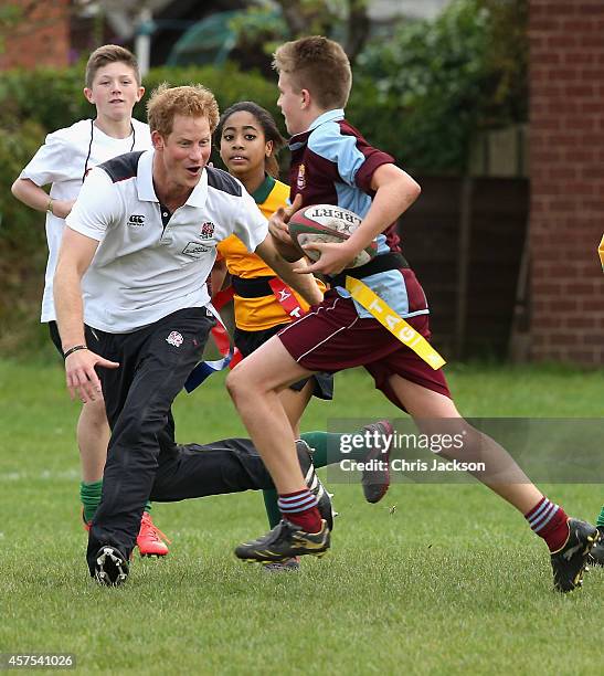 Prince Harry, Patron of England Rugby's All Schools Programme, plays touch rugby against schoolchildren during a teacher training session at Eccles...