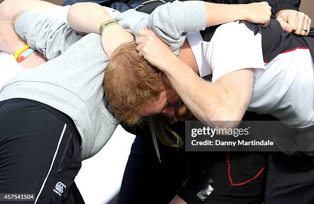 Prince Harry, Patron of England Rugby's All Schools Programme, practices scrummaging with Sarah Hunter as he plays touch rugby against schoolchildren...