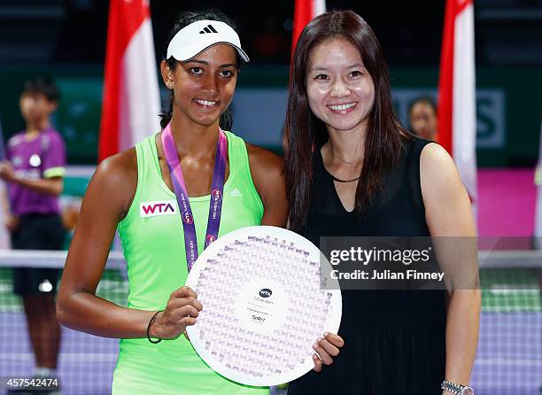 Karman Thandi of India celebrates with the winners trophy next to Li Na of China after defeating Hsiang-Wen Huang of Taipe during day one of the BNP...