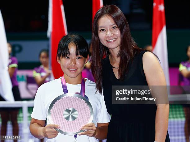 Yuki Ando of Japan with her runners up trophy next to Li Na of China in the U14 Future Stars final during day one of the BNP Paribas WTA Finals...