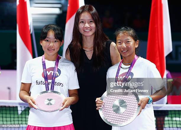 Winner Thasaporn Naklo of Thailand, runner up Yuki Ando of Japan with their trophies next to Li Na of China after the U14 Future Stars final during...
