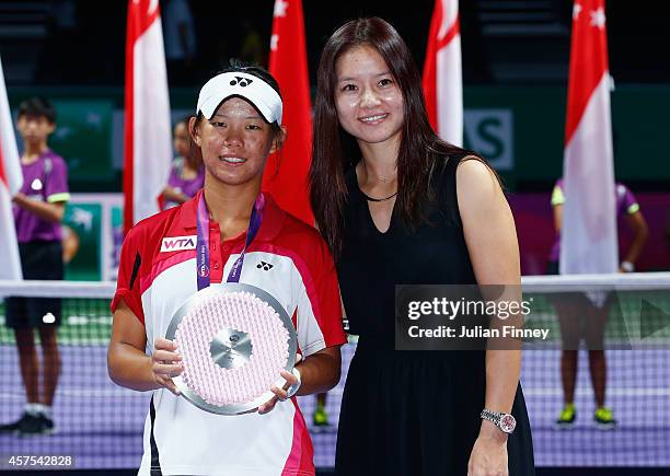 Runner up Hsiang-Wen Huang of Taipei and Li Na of China pose for a photo after the Future Stars U16 final during day one of the BNP Paribas WTA...