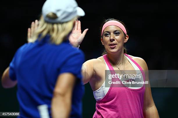 Martina Navratilova of the United States and Marion Bartoli of France celebrate a point on their way to victory against Tracy Austin of the United...