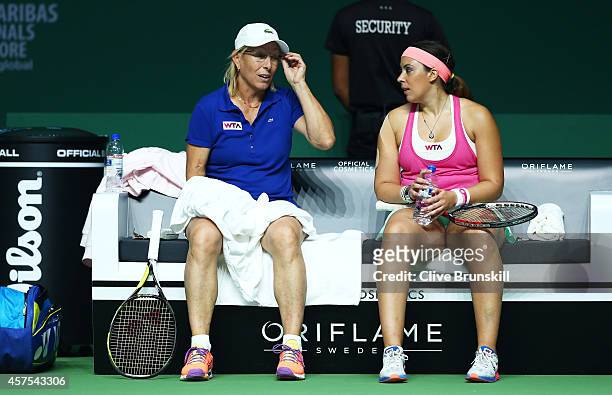 Martina Navratilova of the United States and Marion Bartoli of France chat during the change in their match against Tracy Austin of the United States...