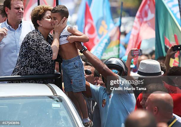 Brazilian president and presidential candidate of the Workers Party Dilma Rousseff kisses a boy during a campaign visit on October 20, 2014 in the...