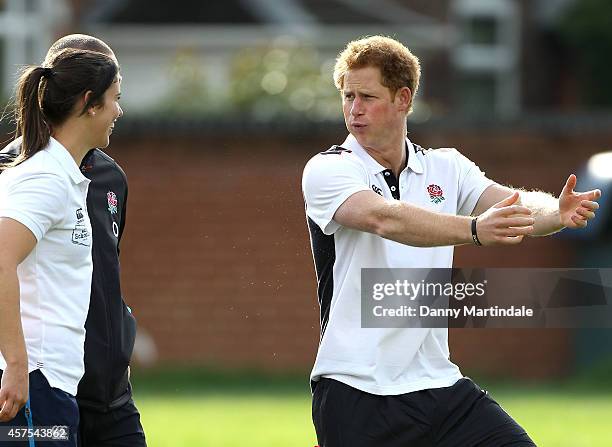 Prince Harry jokes with Sarah Hunter of the women's England rugby team at a teacher training session and rugby festival at Eccles RFC on October 20,...