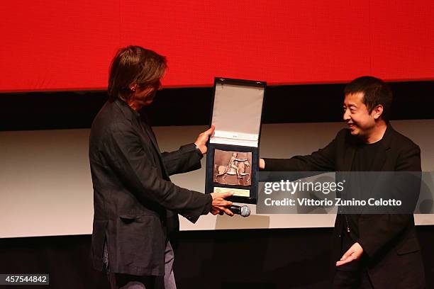 Walter Salles is awarded by Jia Zhangke with the Marc Aurelio Award during the 9th Rome Film Festival on October 20, 2014 in Rome, Italy.