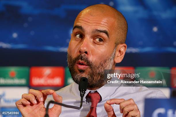 Josep Guardiola, head coach of Bayern Muenchen talks to the media during a press conference prior to their UEFA Champions League match against AS...