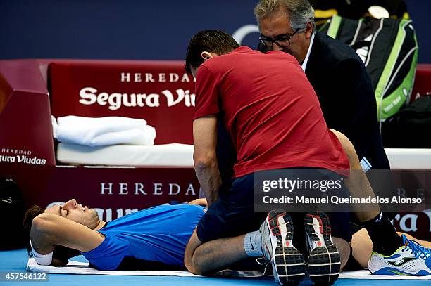 Marcel Granollers of Spain receives treatment in his match against Pablo Carreno Busta of Spain during day one of the ATP 500 World Tour Valencia...