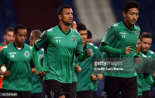 Nani warms up with Junya Tanaka and other team mates during a Sporting Club de Portugal training session at Veltins Arena on October 20, 2014 in...