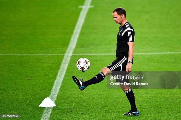 Head coach Frank de Boer of AFC Ajax juggles the ball during a training session ahead of their UEFA Champions League Group F match against FC...