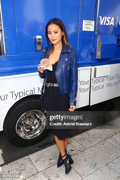 Jamie Chung teams up with Visa and Chase to celebrate the launch of Apple Pay with free doughnuts for all New Yorkers from Dough on October 20, 2014...