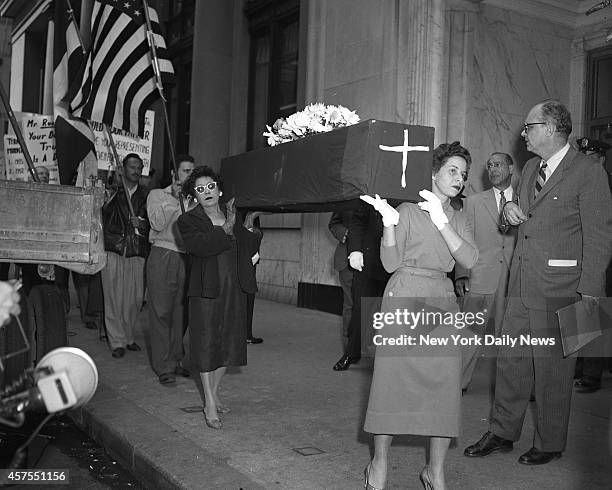 Protesting, two women carry mock coffin in picket line in front of Franklin D. Roosevelt Jr.'s law office at 598 Madison Ave. They protested against...