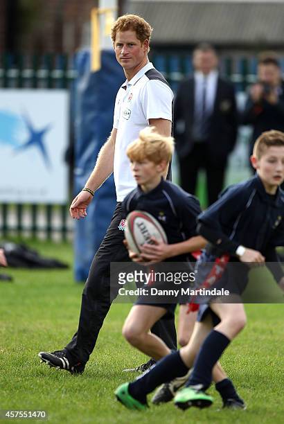 Prince Harry, Patron of England Rugby's All Schools Programme, watches schoolchildren play touch rugby during a teacher training session at Eccles...