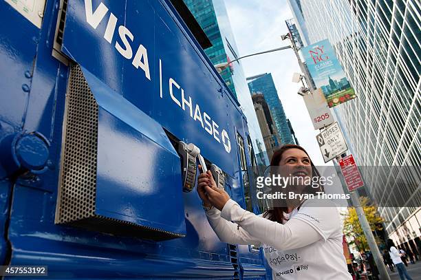 Ursula Anderman teaches New York pedestrians how to use Apple Pay, as part of a Visa/Chase promotion, on October 20, 2014 in New York, NY. The...