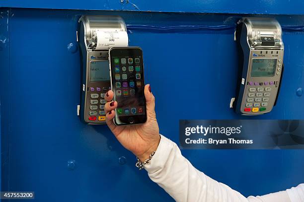 Ursula Anderman teaches New York pedestrians how to use Apple Pay, as part of a Visa/Chase promotion, on October 20, 2014 in New York, NY. The...