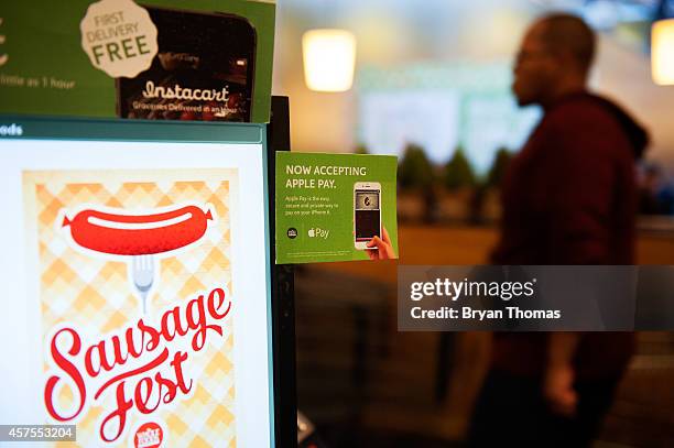 Apple Pay is promoted on signs placed at the cash register of Whole Foods in Columbus Circle on October 20, 2014 in New York, NY. The software, which...