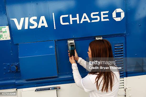 Ursula Anderman teaches New York pedestrians how to use Apple Pay, as part of a Visa/Chase promotion, on October 20, 2014 in New York, NY. The...