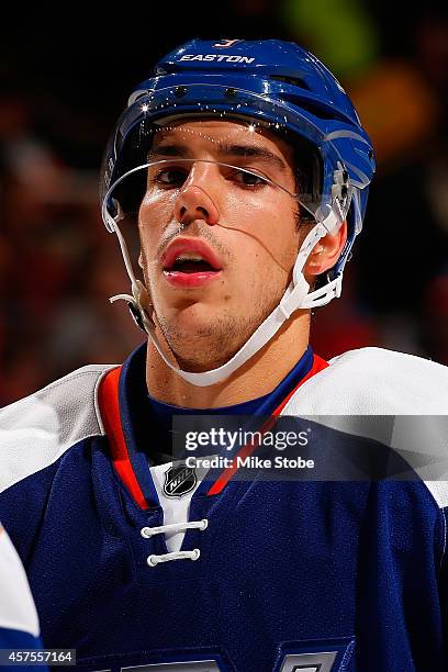 Travis Hamonic of the New York Islanders skates against the San Jose Sharks at Nassau Veterans Memorial Coliseum on October 16, 2014 in Uniondale,...