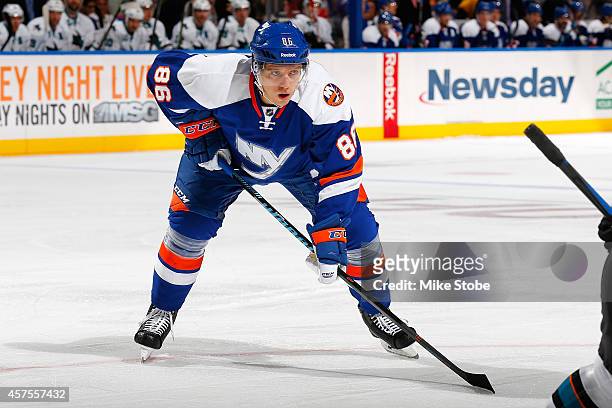 Nikolai Kulemin of the New York Islanders skates against the San Jose Sharks at Nassau Veterans Memorial Coliseum on October 16, 2014 in Uniondale,...