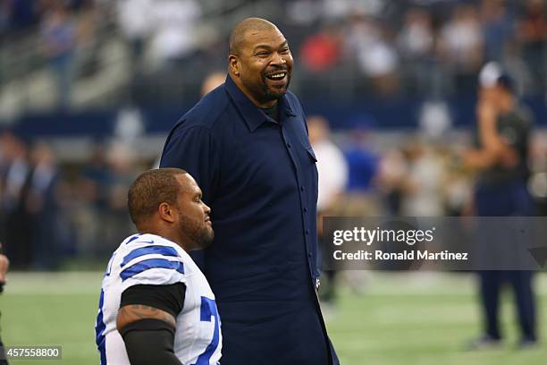 Former NFL player Larry Allen talks with Mackenzy Bernadeau of the Dallas Cowboys at AT&T Stadium on October 19, 2014 in Arlington, Texas.