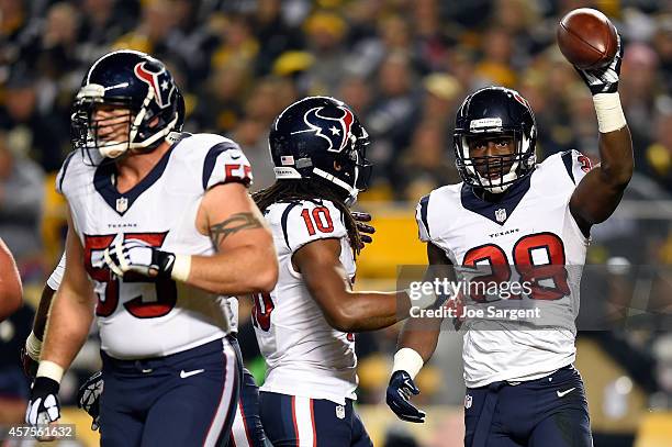 Alfred Blue of the Houston Texans celebrates with his teammate DeAndre Hopkins after scoring an 11 yard touchdown pass thrown by Ryan Fitzpatrick in...
