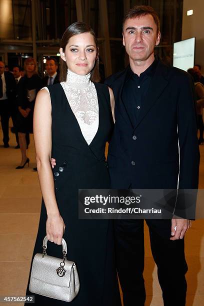 Marion Cotillard and Raf Simons attend the Foundation Louis Vuitton Opening at Foundation Louis Vuitton on October 20, 2014 in Boulogne-Billancourt,...