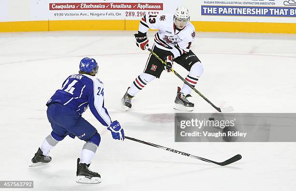 Graham Knott of the Niagara Ice Dogs trys to get past Evan de Haan of the Sudbury Wolves during an OHL game between the Sudbury Wolves and the...