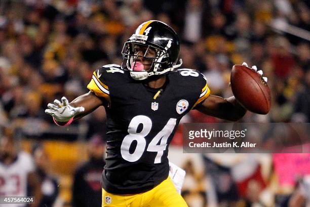 Antonio Brown of the Pittsburgh Steelers throws a touchdown pass to Lance Moore in the second quarter against the Houston Texans during their game at...