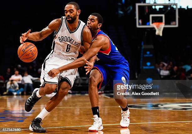 Alan Anderson of the Brooklyn Nets attempts to drive past Hollis Thompson of the Philadelphia 76ers in a preseason game at the Barclays Center on...