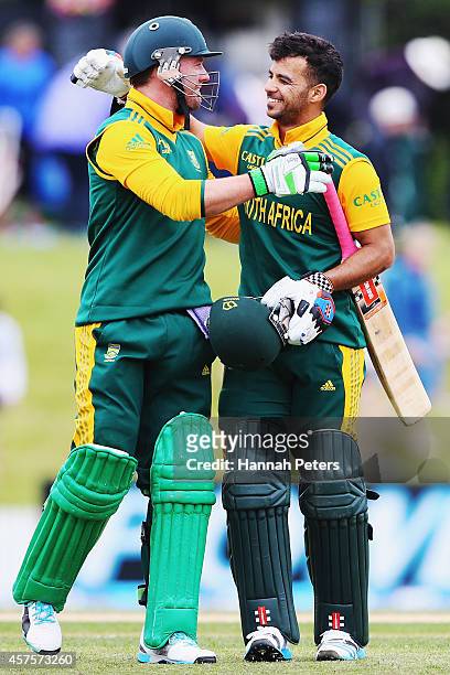 De Villiers and Jean-Paul Duminy of South Africa celebrate after winning the One Day International match between New Zealand and South Africa at Bay...