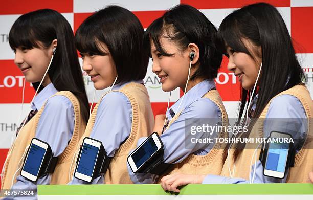 Natsumi Matsuoka, Sakura Miyawaki, Haruka Kodama and Rino Sashihara, members of HKT48, a girls pop group pose in a photo session to promote Lotte's...