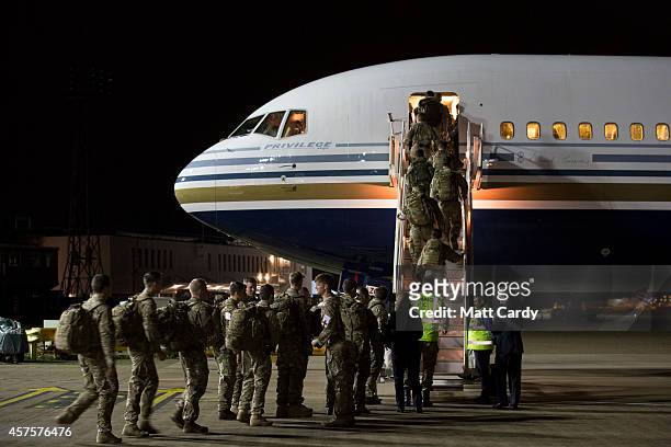 British Army medics board an aircraft as they depart for Sierra Leone at RAF Brize Norton on October 21, 2014 in Brize Norton, England. The medics...