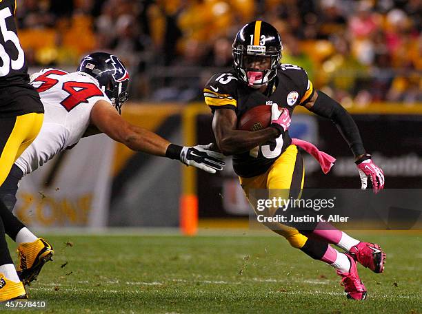 Dri Archer of the Pittsburgh Steelers rushes during the game against Mike Mohamed of the Houston Texans on October 20, 2014 at Heinz Field in...