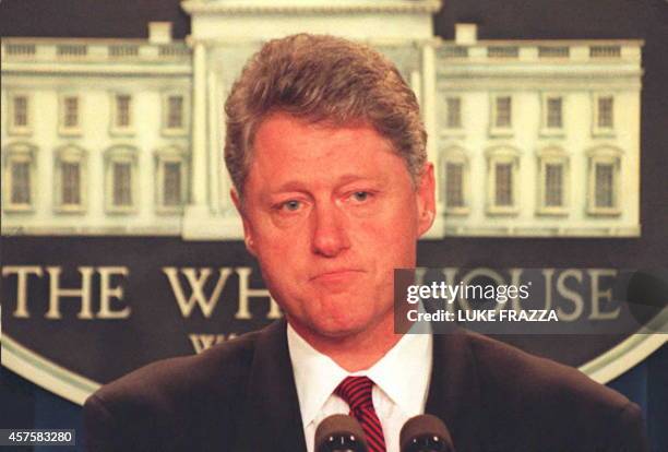 President Bill Clinton listens to reporters questions during a late 19 April press conference at the White House on the Oklahoma City bomb explosion...