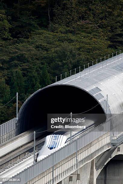 An L0 series magnetic levitation train, developed by Central Japan Railway Co., travels along on an elevated track during a trial run at the...