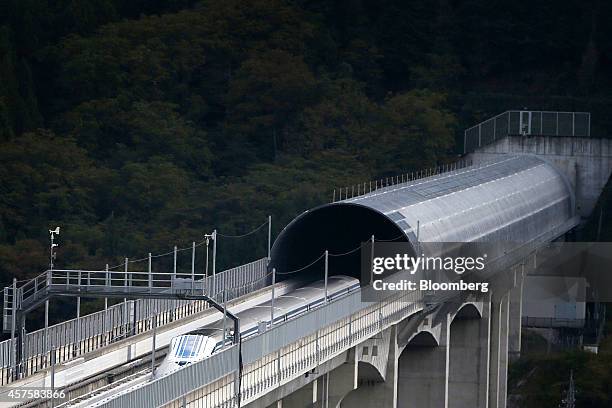 An L0 series magnetic levitation train, developed by Central Japan Railway Co., travels along on an elevated track during a trail run at the...