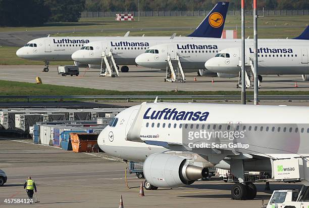 Passenger planes of German ariline Lufthansa stand parked on the tarmac at Tegel Airport during a two-day strike by Lufthansa pilots on October 21,...