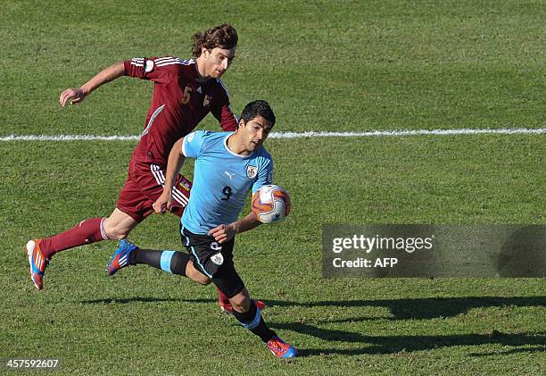 Uruguayan football player Luis Suarez vies for the ball during the Brazil 2014 FIFA World Cup South American qualifier match Uruguay vs Venezuela...